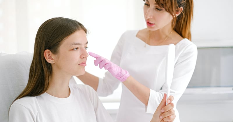 A Woman Consulting with a Cosmetologist Doctor
