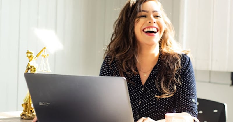 Woman at laptop smiling