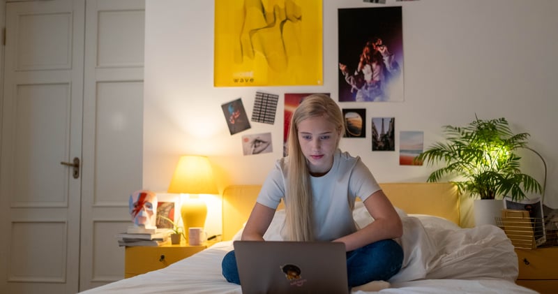 A Female Teenager Using Her Laptop
