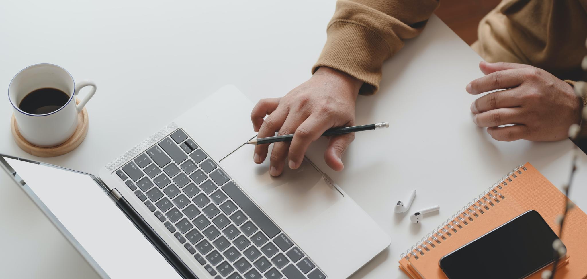 A person with no experience creating a resume on laptop