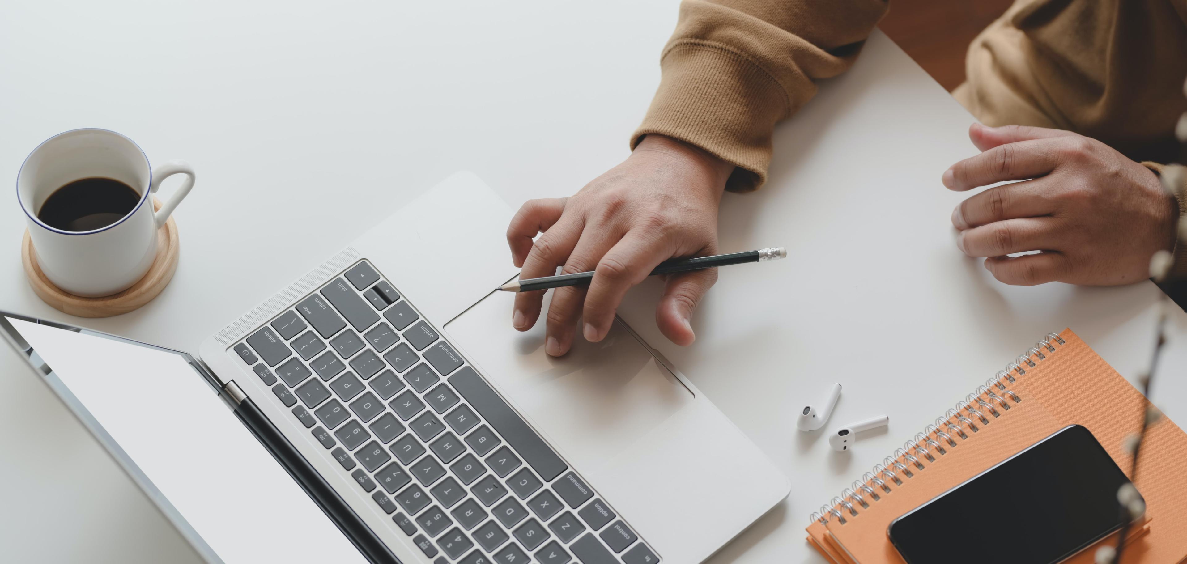 A person with no experience creating a resume on laptop