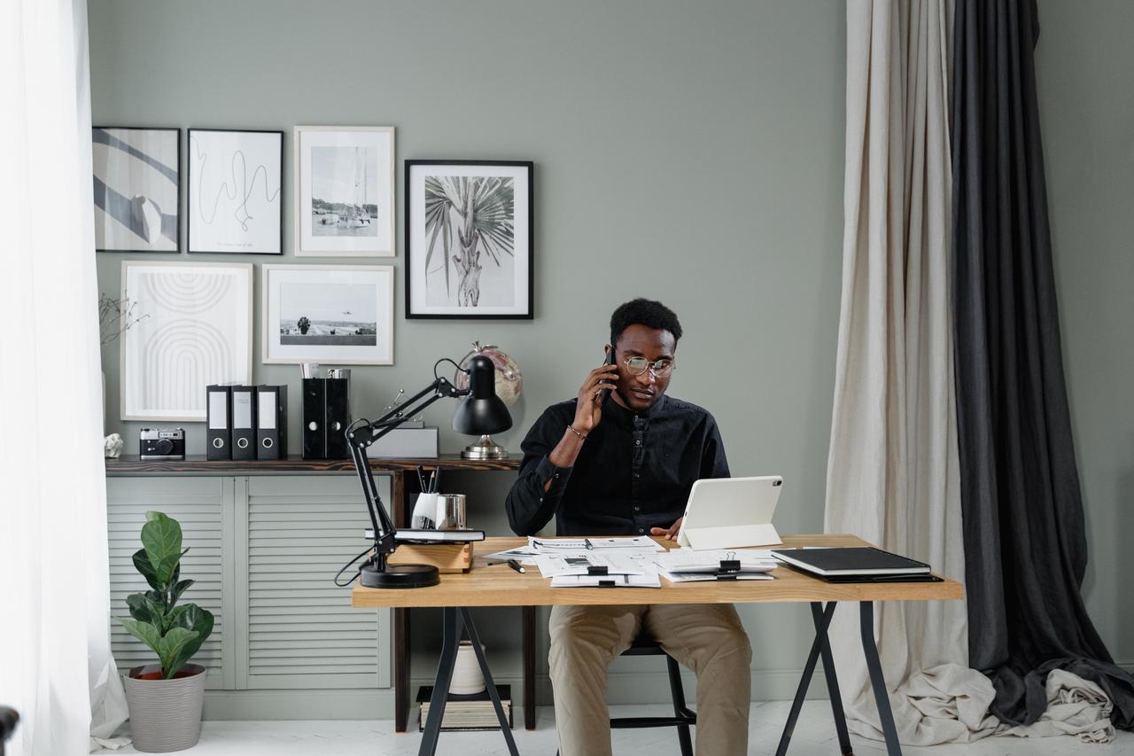Man taking a phone call at a home office desk, from the accountant career guide