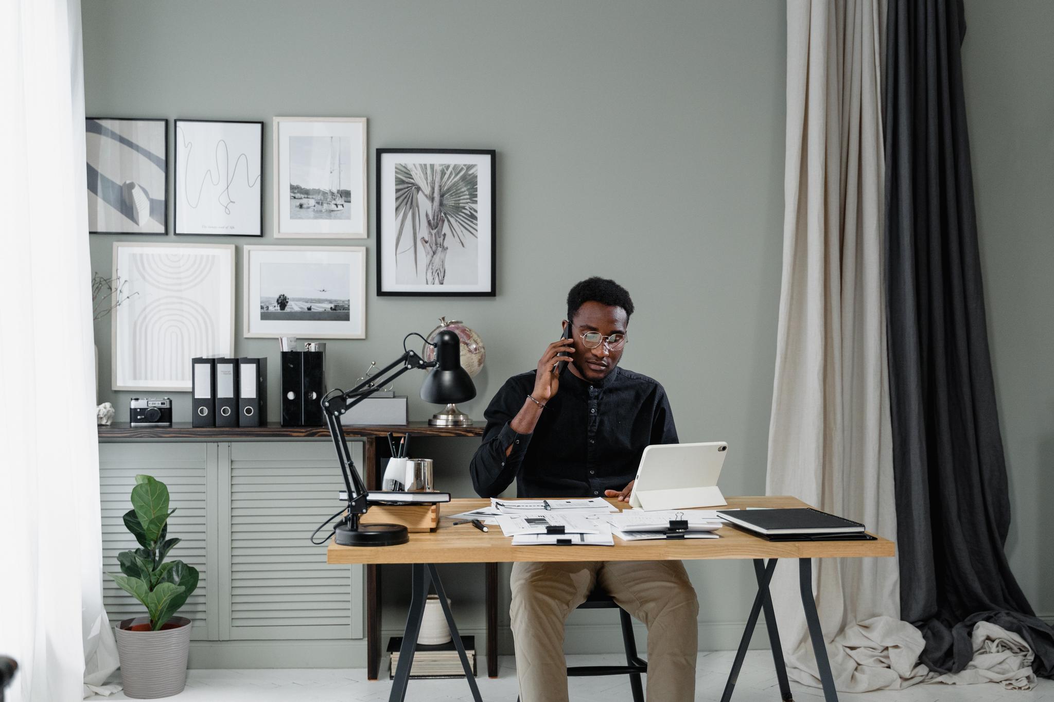 Man taking a phone call at a home office desk, from the accountant career guide