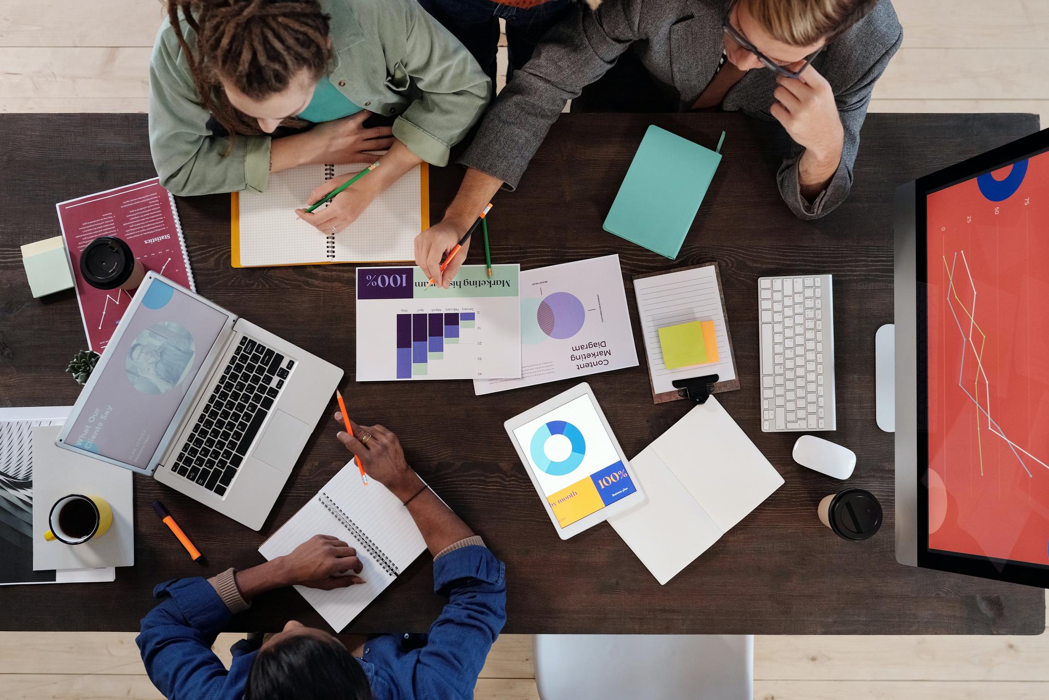 Overhead view of a team reviewing charts and laptops, from the data entry resume guide