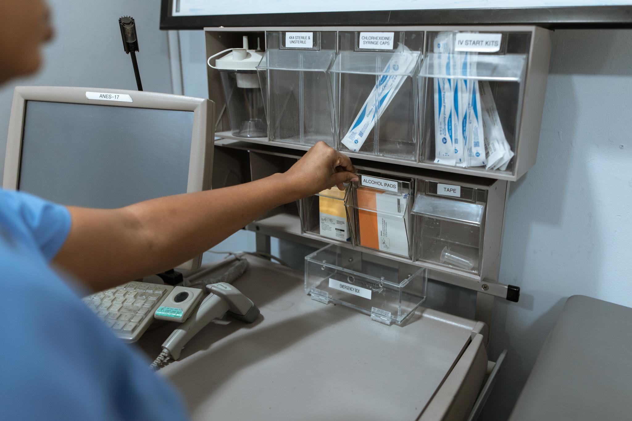 Healthcare worker selecting sterilized instrument packs in a clinic, from the nurse practitioner career guide