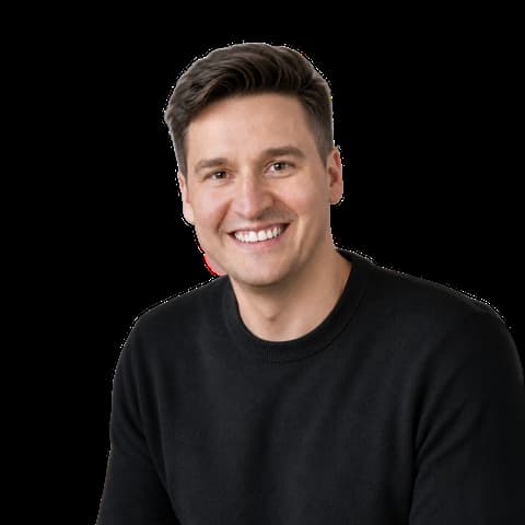 Steve Zimmerman, smiling man with short brown hair in a black crew-neck sweater, white background