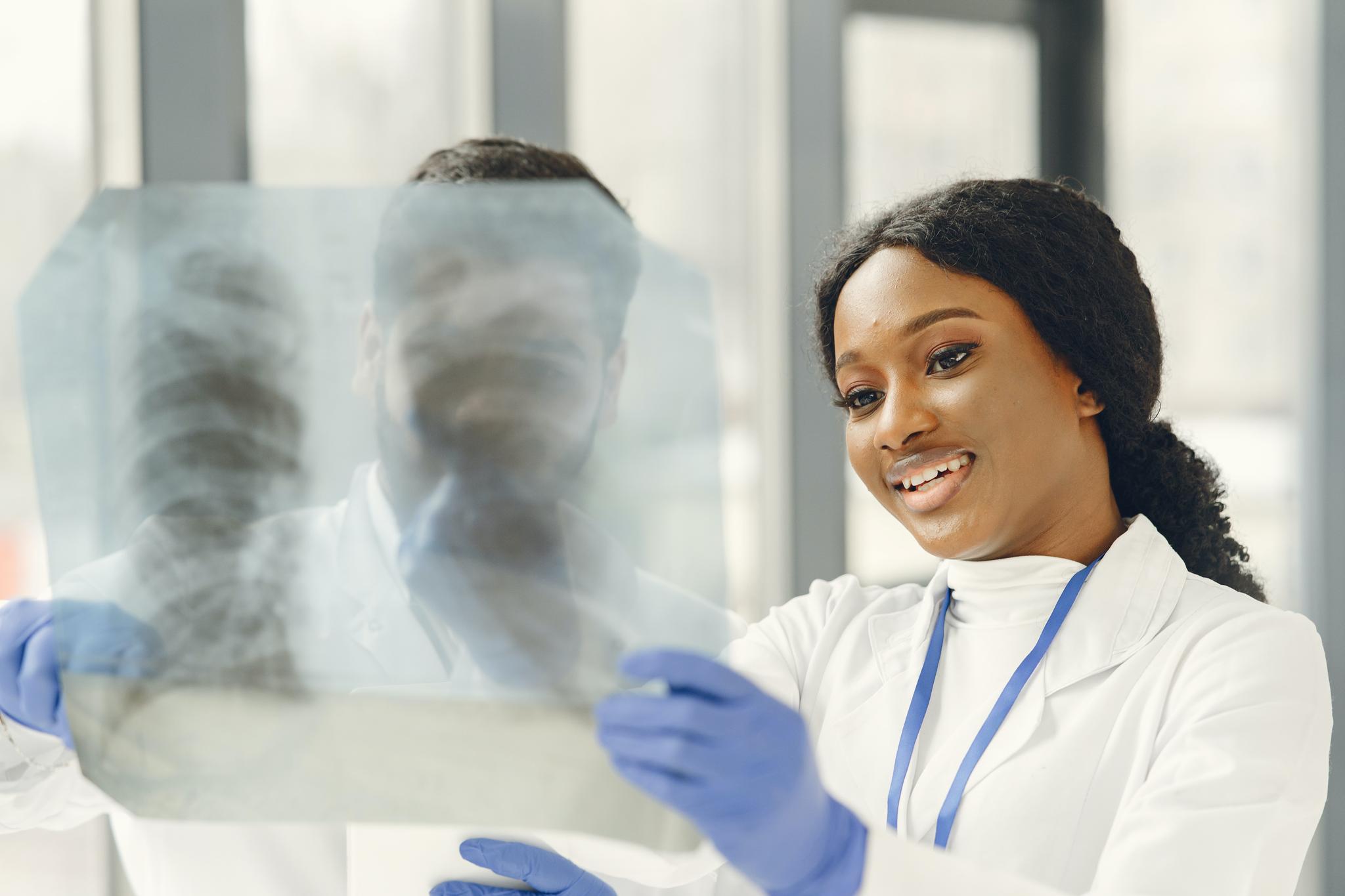 Medical professional examining a chest X-ray with a colleague, from the travel nurse career guide