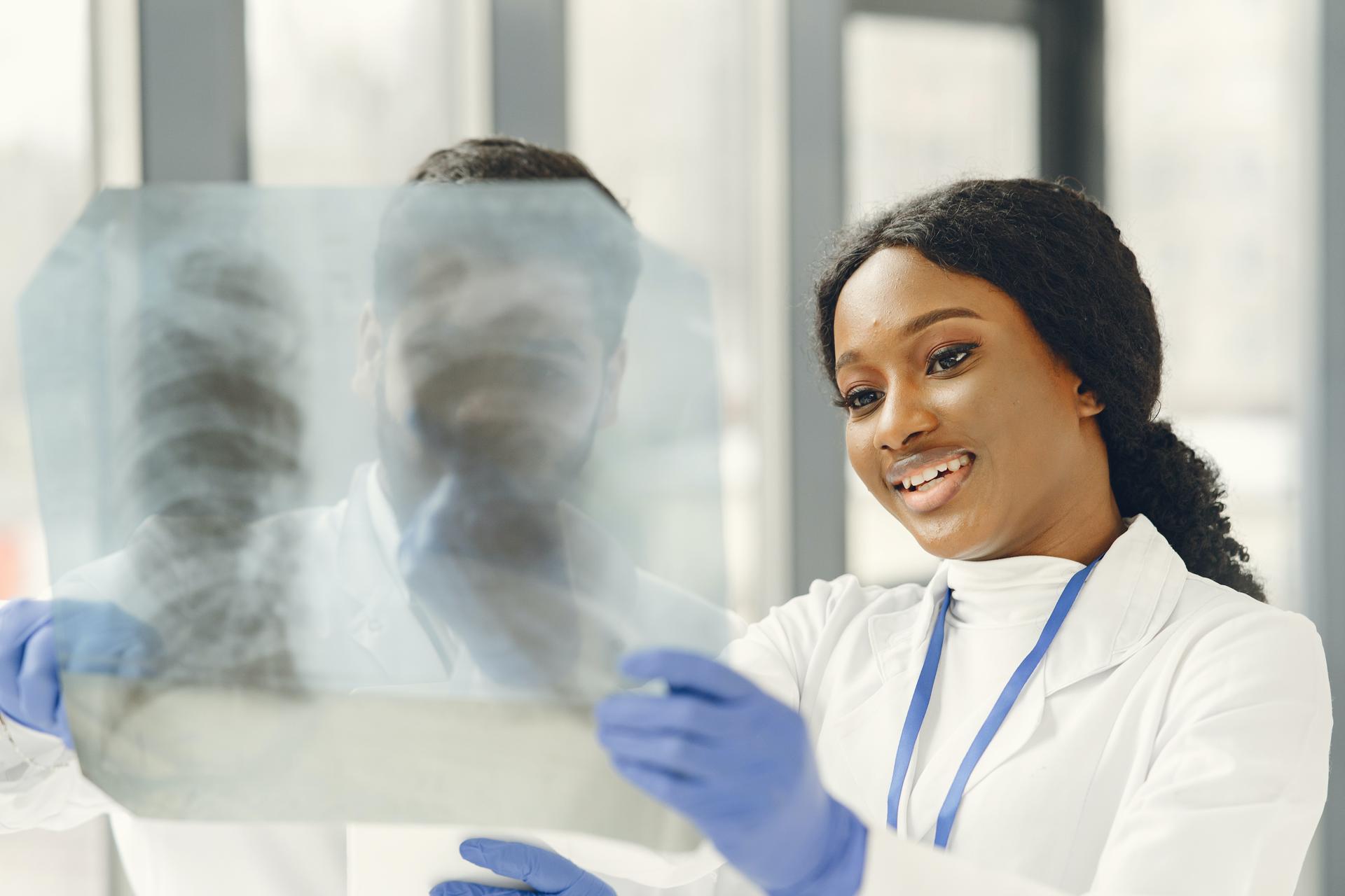 Medical professional examining a chest X-ray with a colleague, from the travel nurse career guide